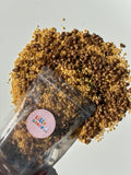 A clear stand-up pouch with a round pink 'Silly Goose' sticker, filled with dried pasta and rice. Sensory filler titled 'Cookie Crumble'